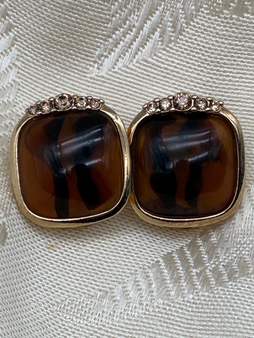 Pair of gold earrings with brown gemstones